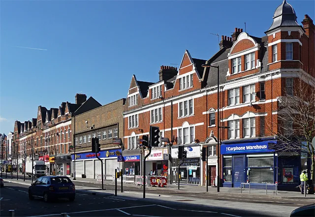 Streatham High Road between numbers 138 and 184, the parade that includes the TG Jones shop